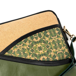 Handbag with green leaf pattern and beige top section on a white background