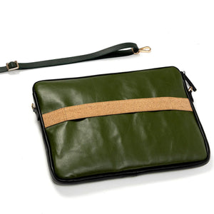 Green vegan leather clutch bag with a brown strap on a white background