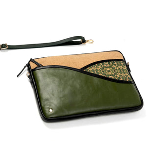 Green vegan leather clutch with beige and patterned sections on a white background