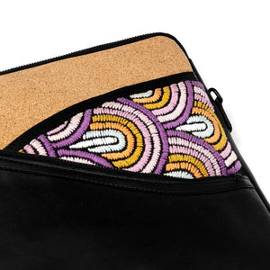 Black pouch with cork border and colorful beaded pattern on a white background