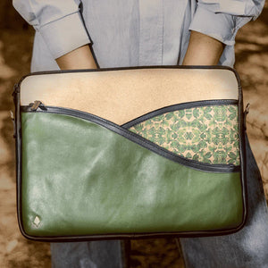 Green and beige bag with floral pattern held by a person