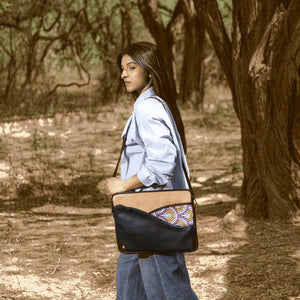 Woman walking through a forest with a patterned bag