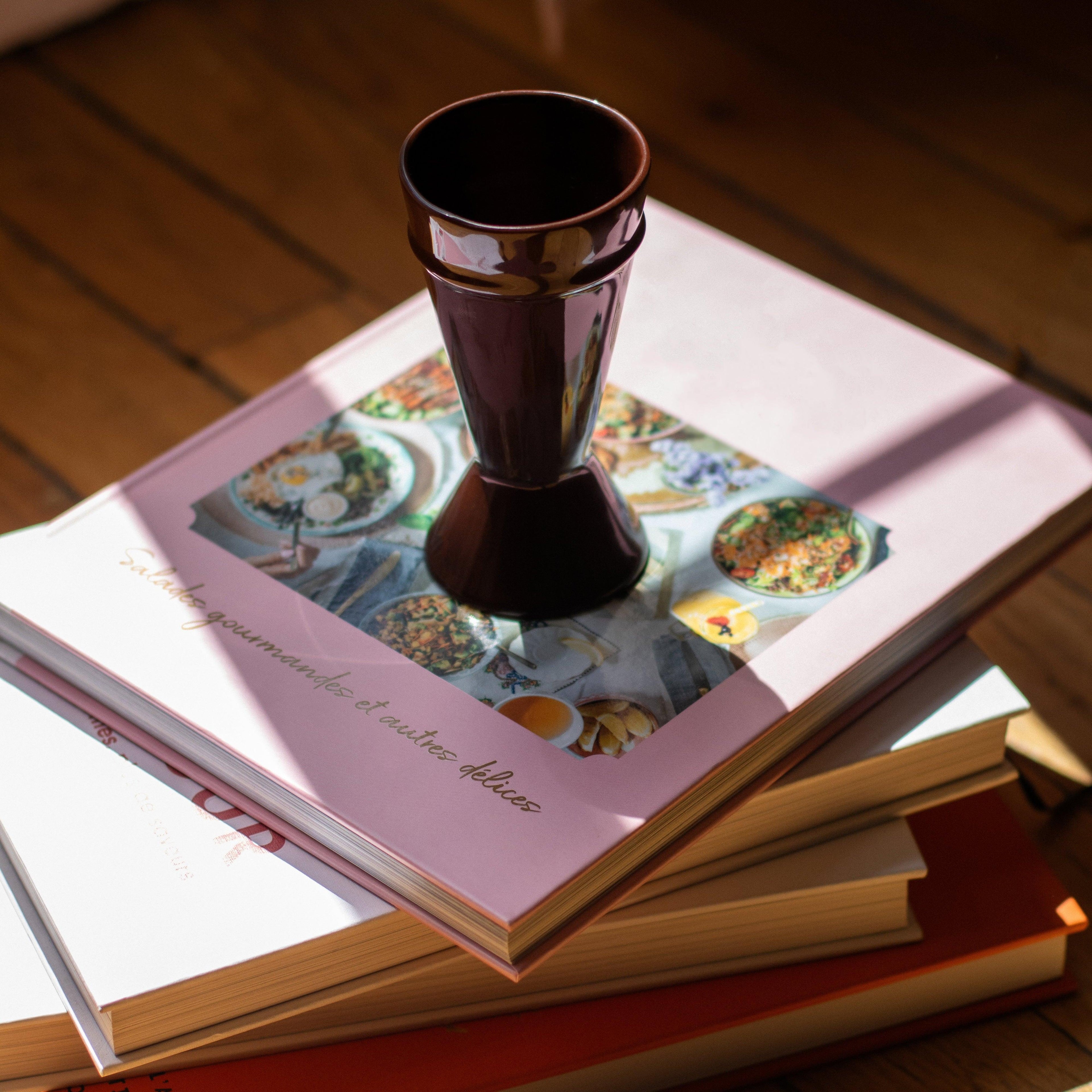 Chocolate coloured Mazagran Coffee Cup sitting on a stack of pink books