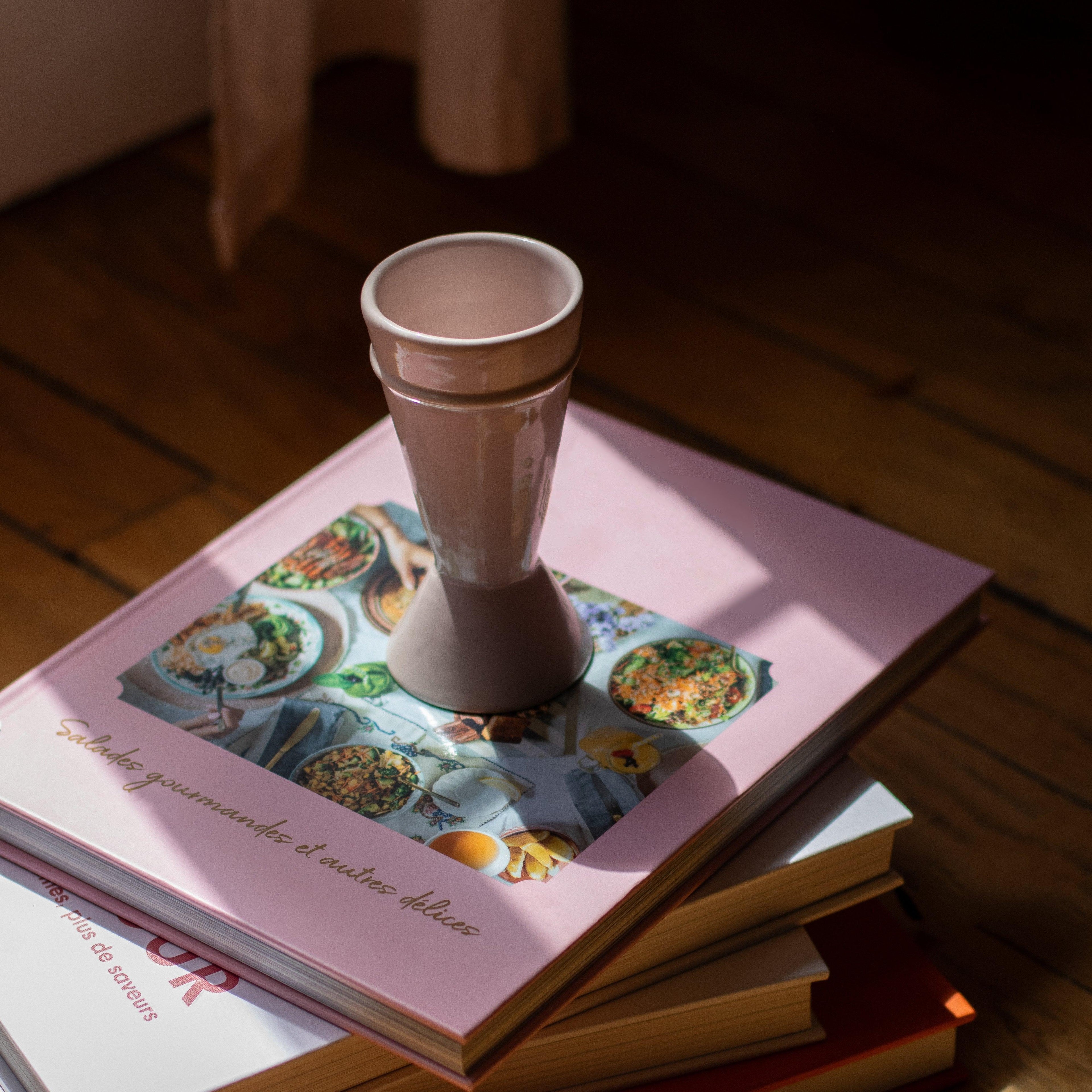 Nude coloured Mazagran Coffee Cup sitting on a stack of pink covered hard back books