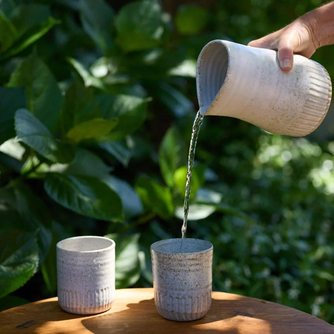 Fluted Carafe Large - Deed Industries shown in use pouring water