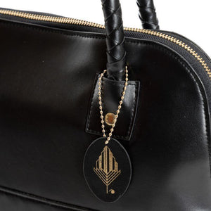 Theia Shoulder Bag image is a close up showing plaited vegan leather handles
