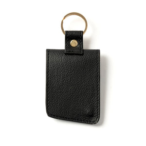 Black leather key fob with gold accent on a white background