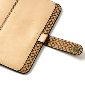 Beige vegan leather diary case with a patterned handle on a white background