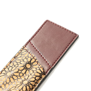 Brown vegan leather pen holder with gold and black patterned flap on a white background