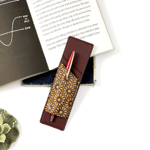 Pen holder with decorative pen on a book