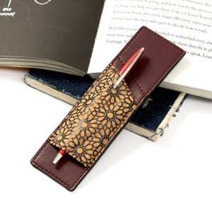Pen holder with gold geometric pattern on a book