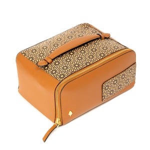 Brown toiletry bag with gold pattern on a white background