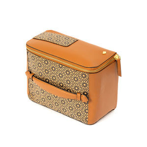 Brown vegan leather handbag with gold floral pattern on a white background