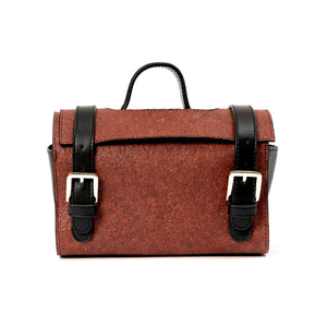 Brown vegan leather bag with black straps and silver buckles on a white background.