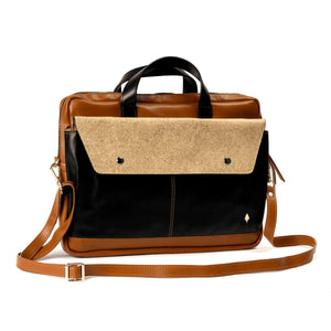 Two-tone brown and black handbag with a shoulder strap on a white background