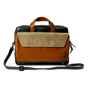 Brown and beige bag with a black strap on a white background