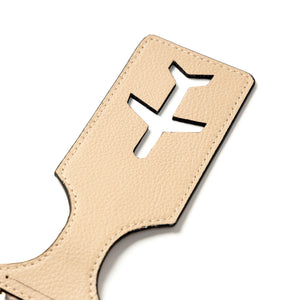 Beige vegan leather luggage tag with cut-out airplane design on a white background