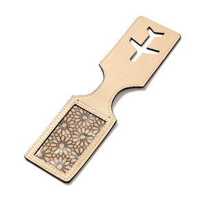 Beige vegan leather product with geometric cutout design on a white background