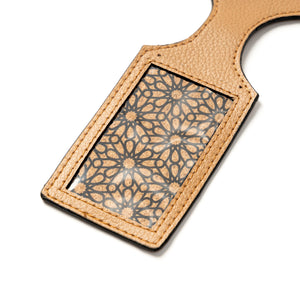 Beige vegan  leather luggage tag with a geometric pattern on a white background