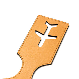 Beige vegan leather luggage tag with airplane cutout on a white background
