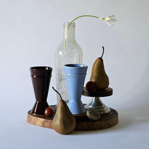 mazagran coffee cups made from upcycled clay on a dark board with white flowers behind