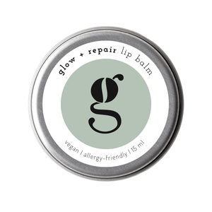 A tin container of grums Glow & Repair Lip Balm, 15ml, with the brand's logo and product information on the label.