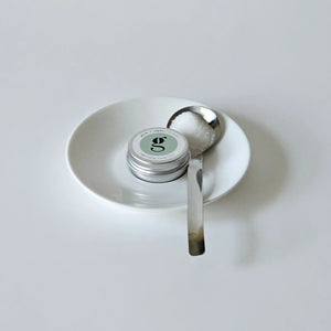 grums vegan lip balm sitting on a white saucer
