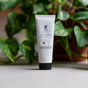 Tube of skincare product with brand logo on a neutral background with plants