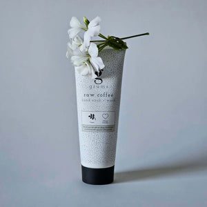 Skincare tube with flowers on a gray background