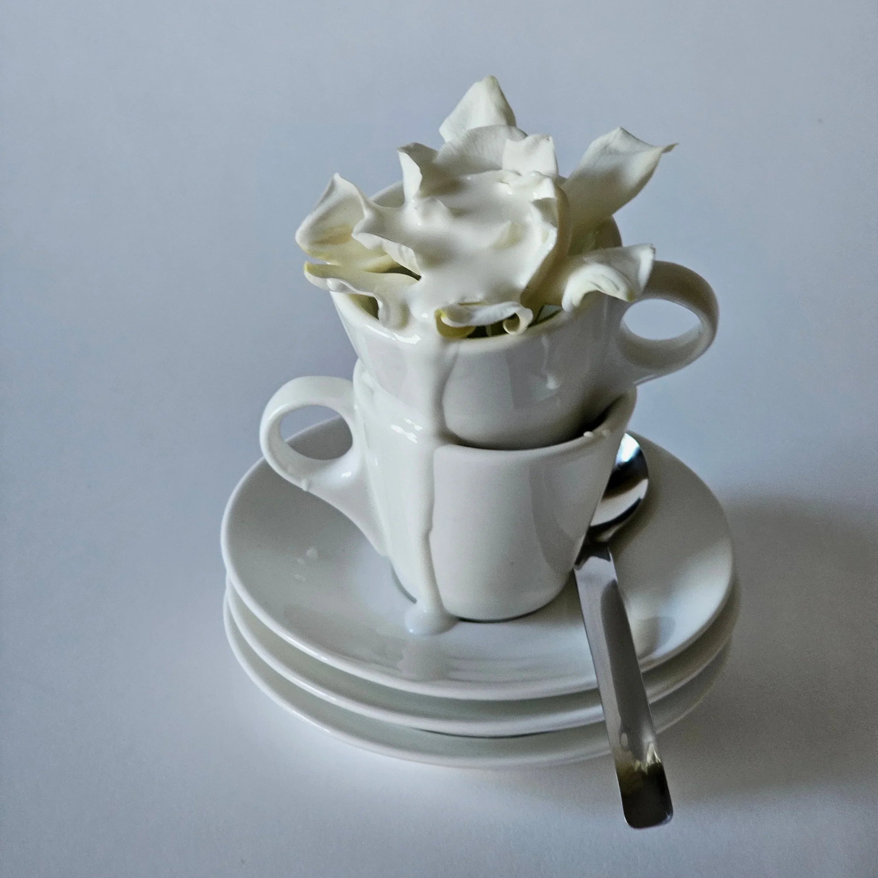 grums liquid mild facial cleansing milk shown poured over a gardenia