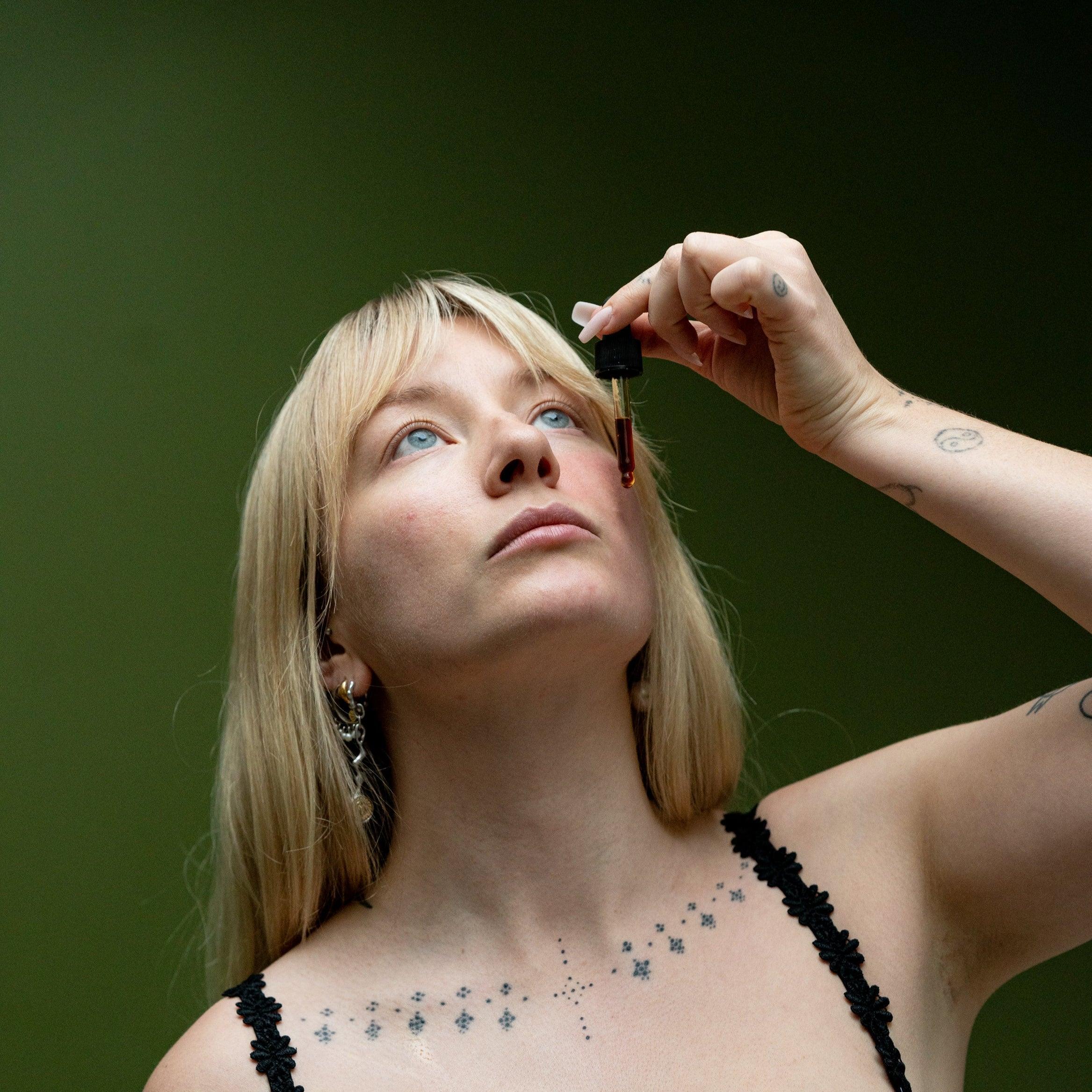 application of coffee oil to the face via a glass dropper