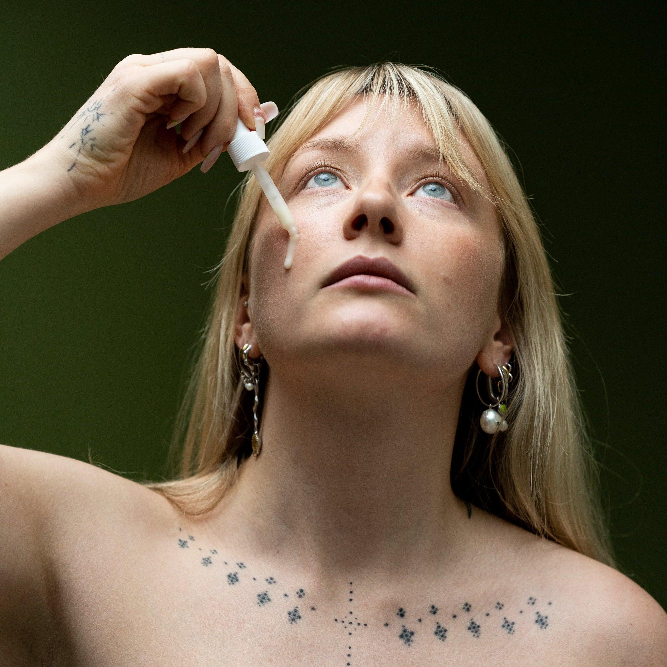 female using grums under eye vegan serum